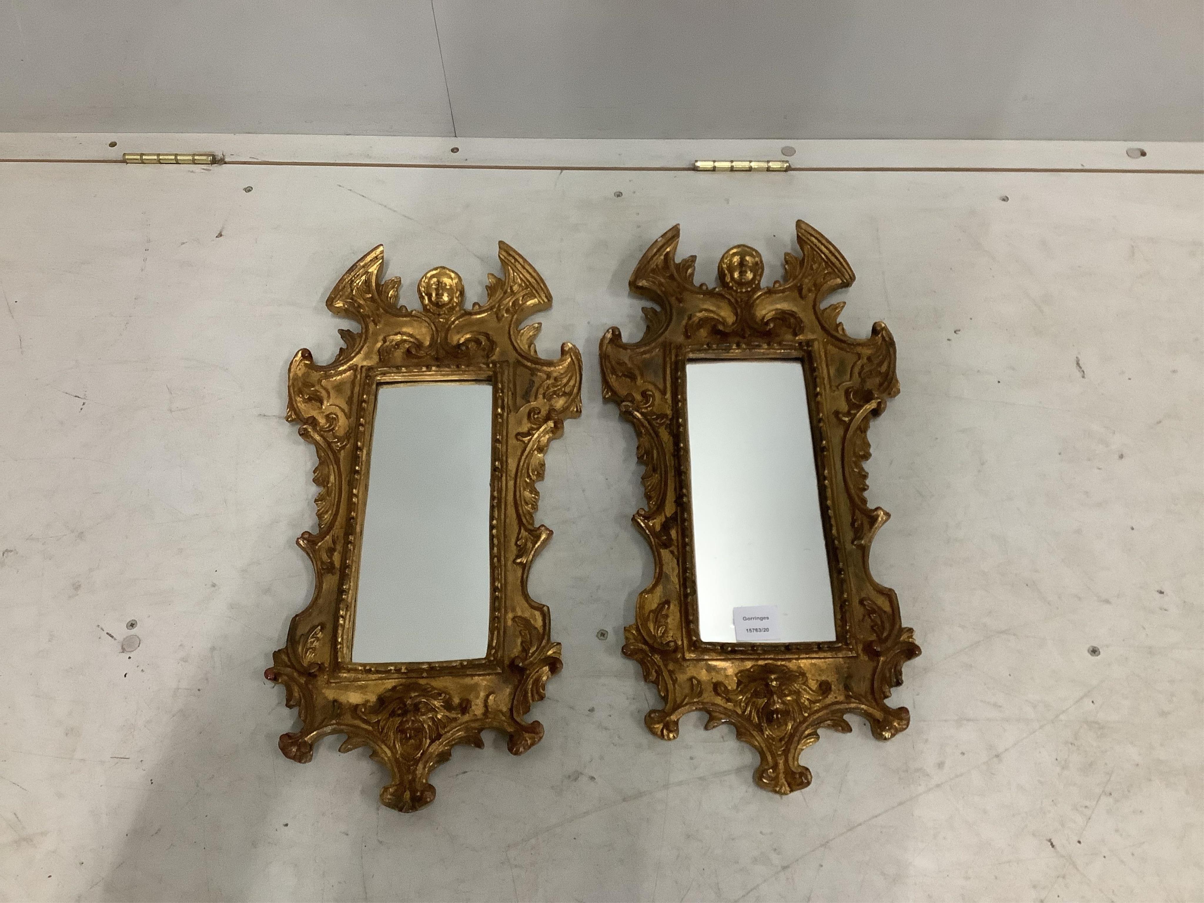 A pair of small reproduction Venetian style gilt composition wall mirrors, width 30cm, height 60cm. Condition - good